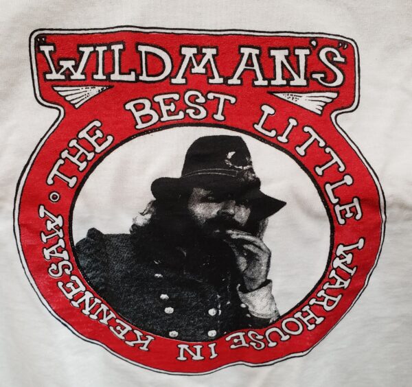 A picture of the wildman 's logo on a t-shirt.