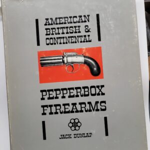 A book about firearms is sitting on the table.