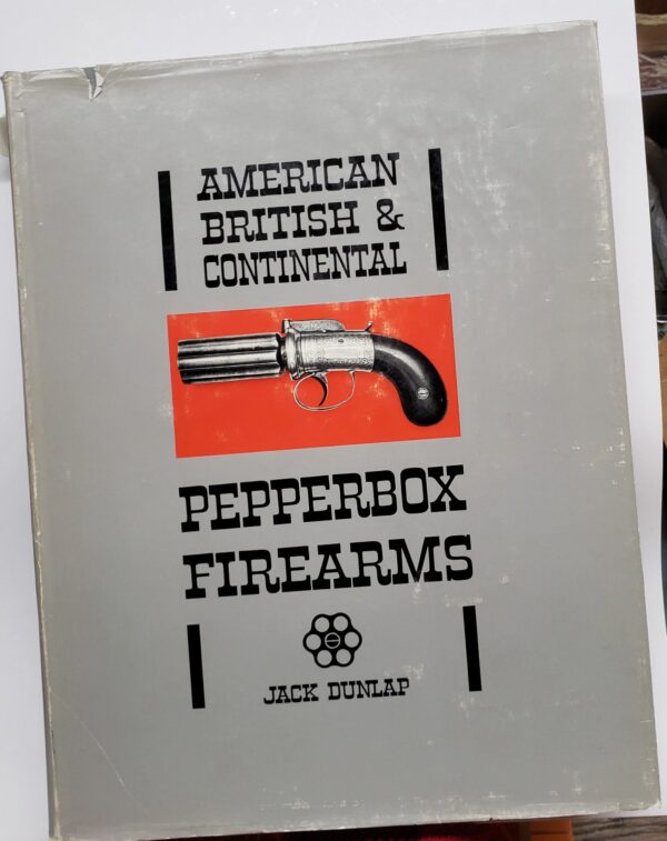 A book about firearms is sitting on the table.