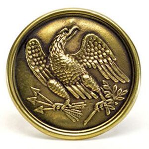 A gold colored metal object with an eagle on it.