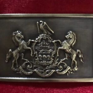 A belt buckle with a horse and rider on it.