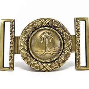 A belt buckle with a palm tree on it.