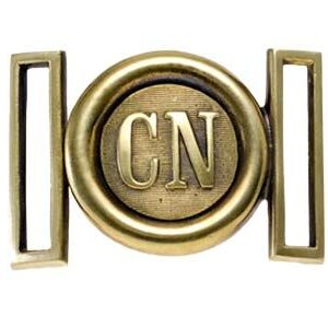 A brass belt buckle with the letters cn on it.