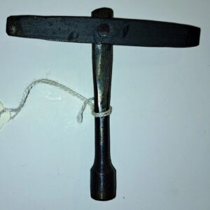 A black wrench with white string hanging from it.