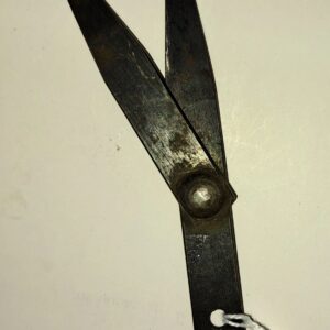 A pair of scissors with a string attached to them.