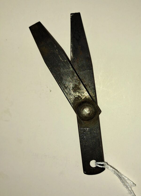 A pair of scissors with a string attached to them.